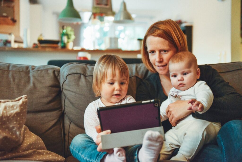 Mother gently holding her babies at home